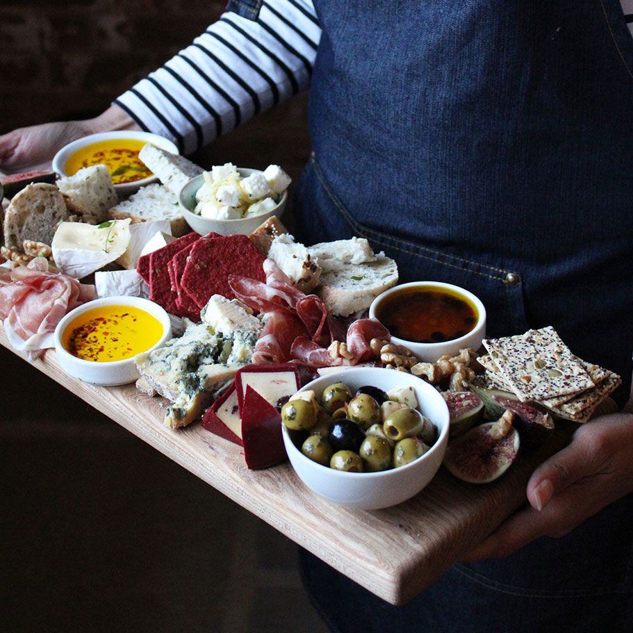 Charcuterie board filled with food and grazing items