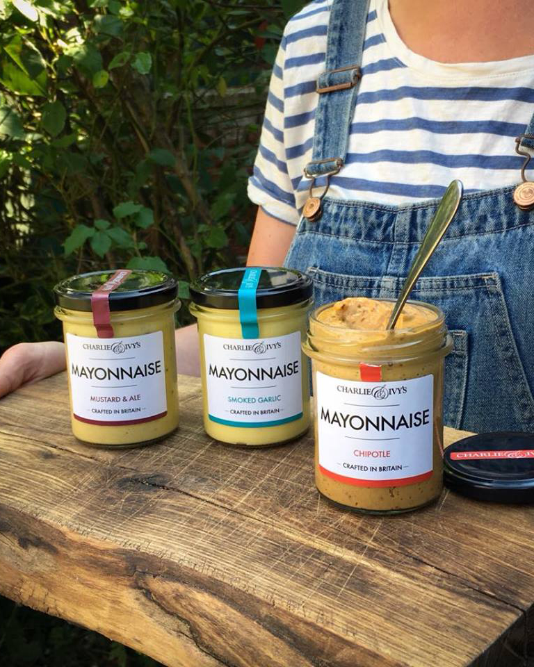 Three Charlie & Ivy's mayonnaise on a wooden board